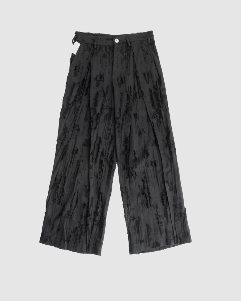 Trousers with overlapping pleats