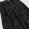 Trousers with overlapping pleats