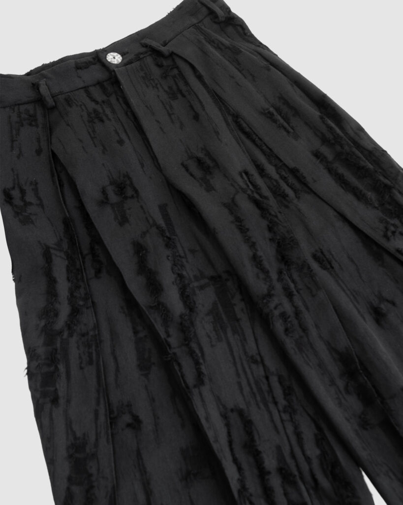 Trousers with overlapping pleats