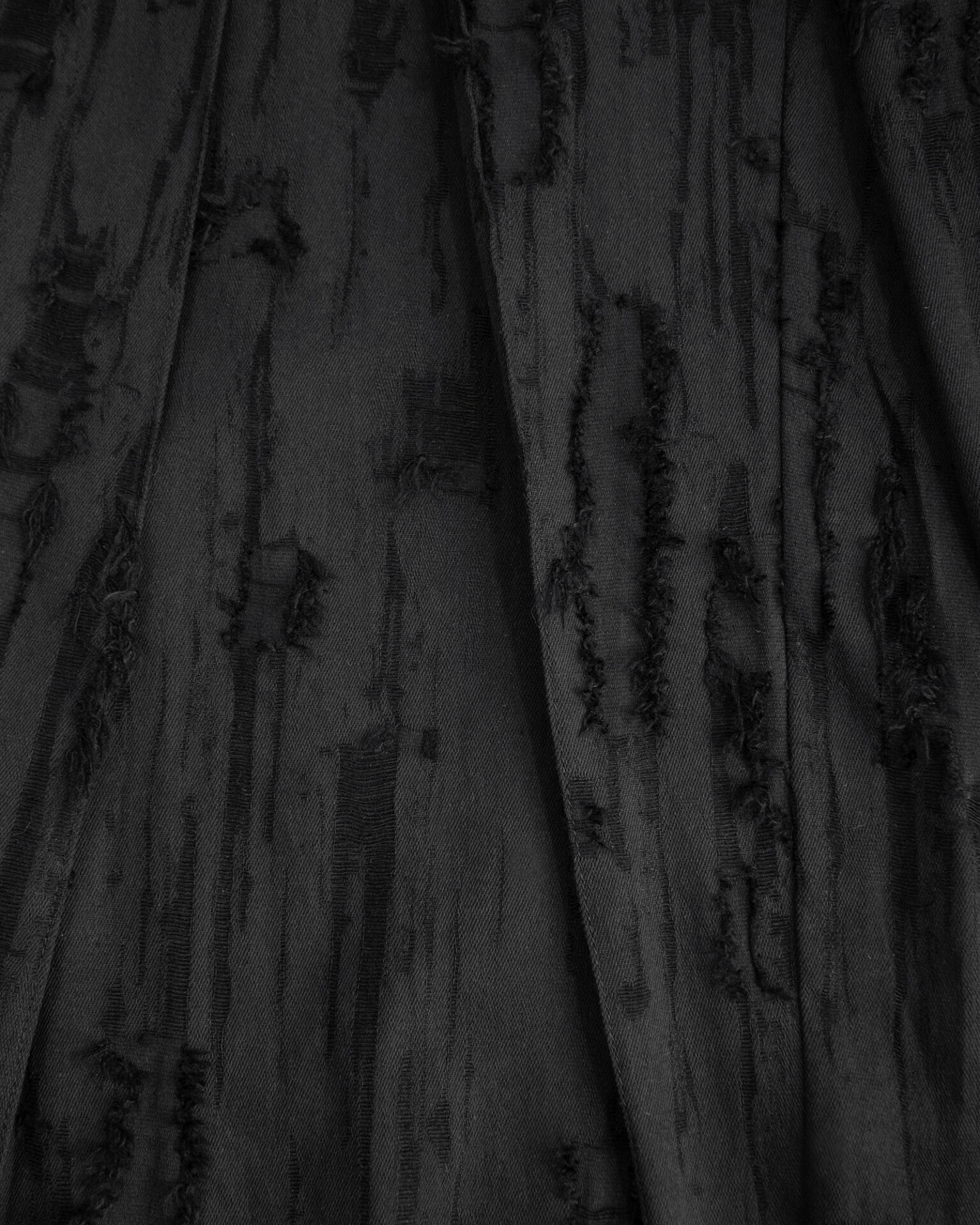 Trousers with overlapping pleats