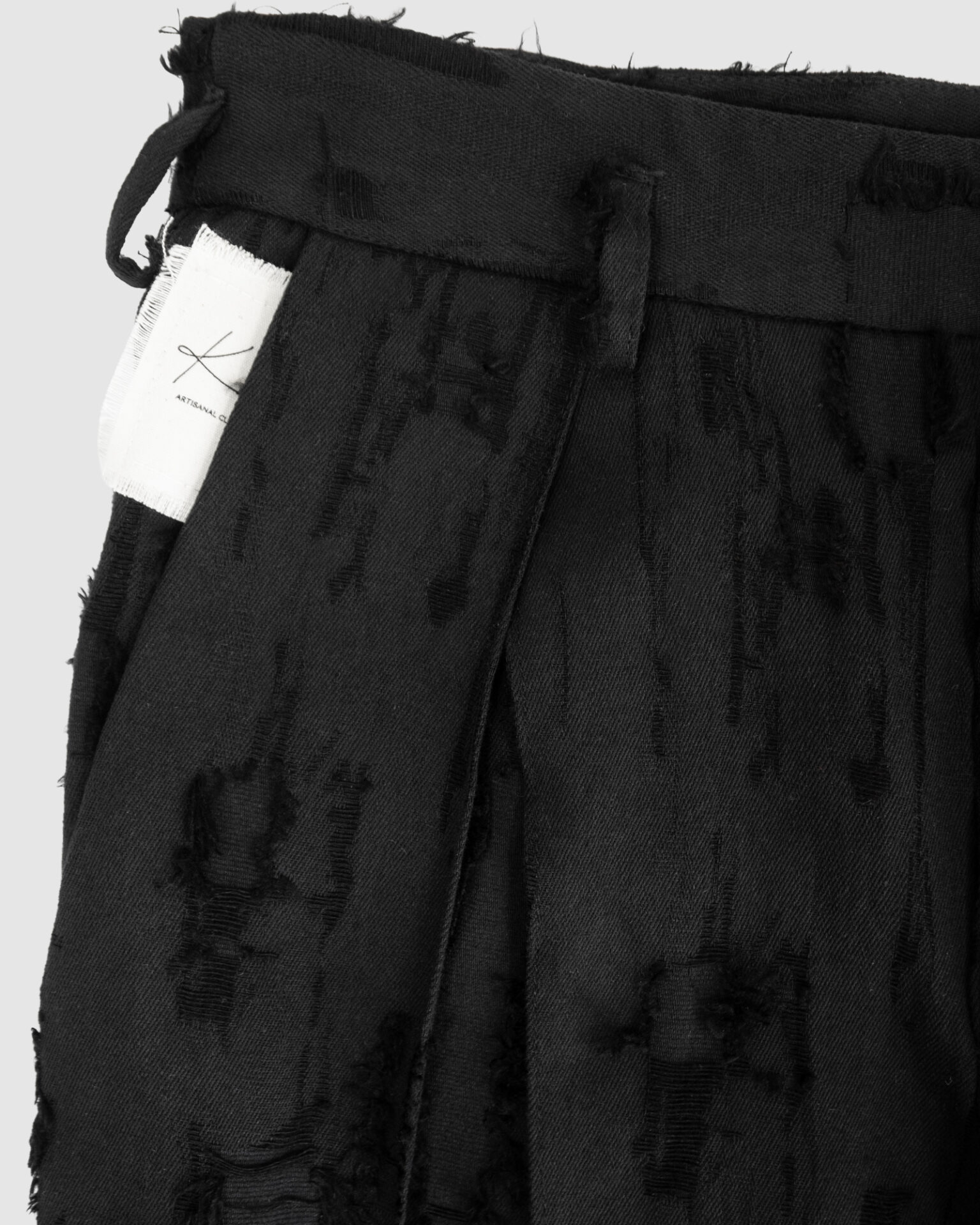 Trousers with overlapping pleats